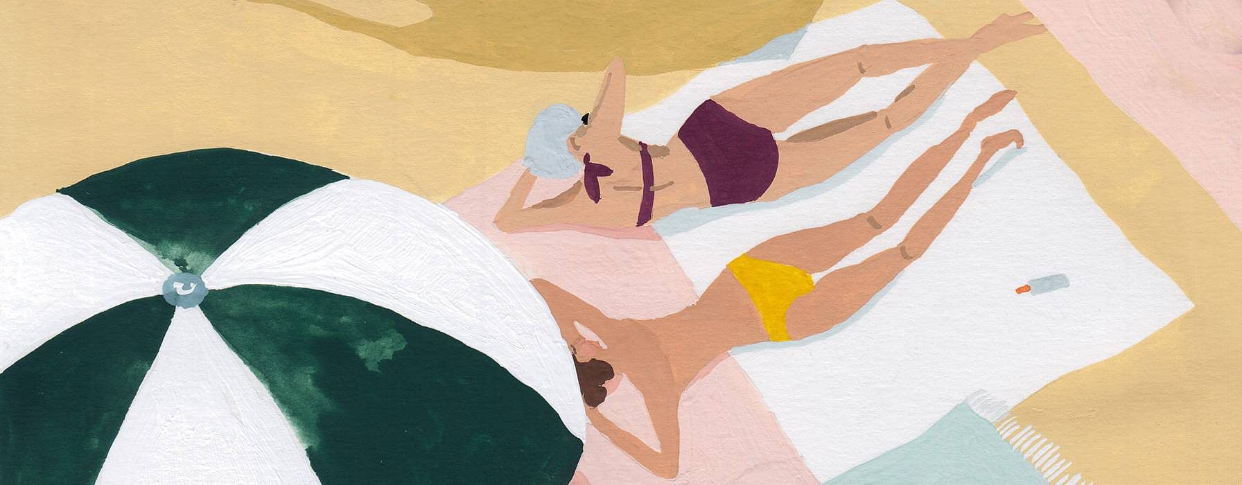 women laying at beach