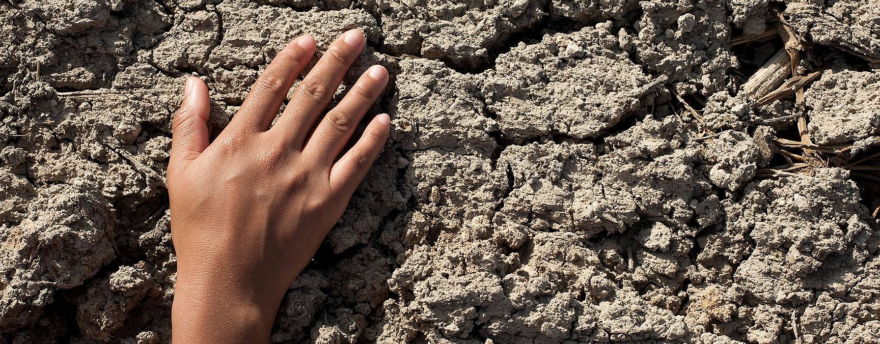 hand on stone wall