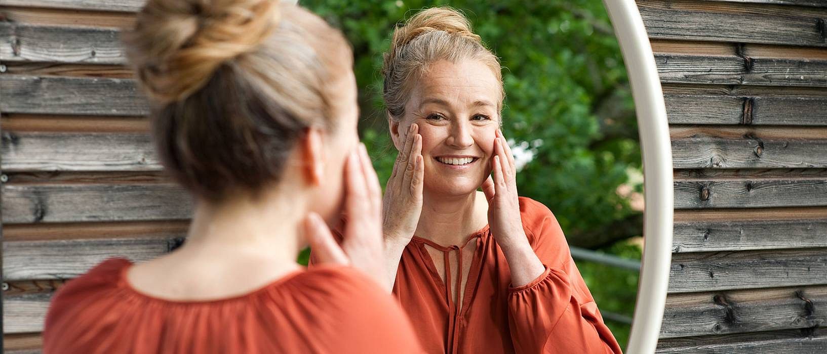Woman seeing herself on a mirror