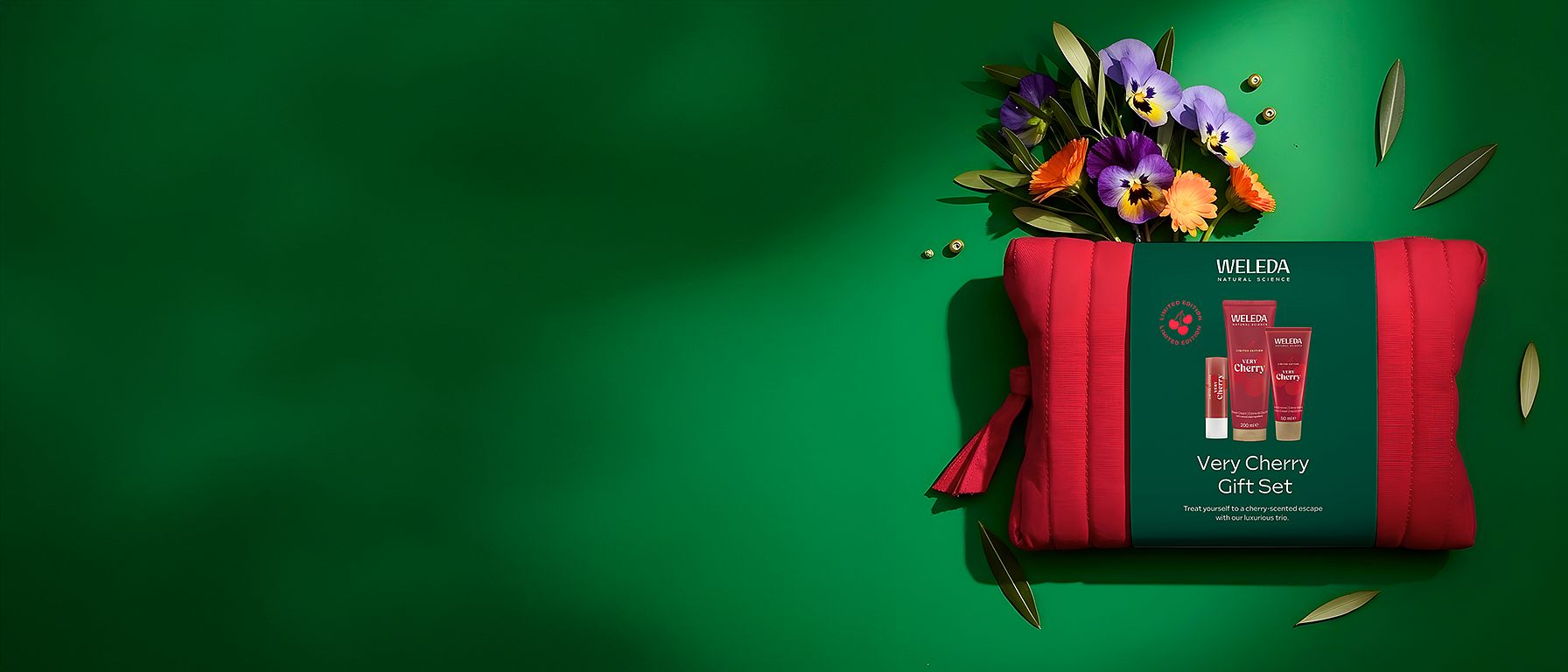 Very Cherry Gift Set surrounded by flowers on a green background.