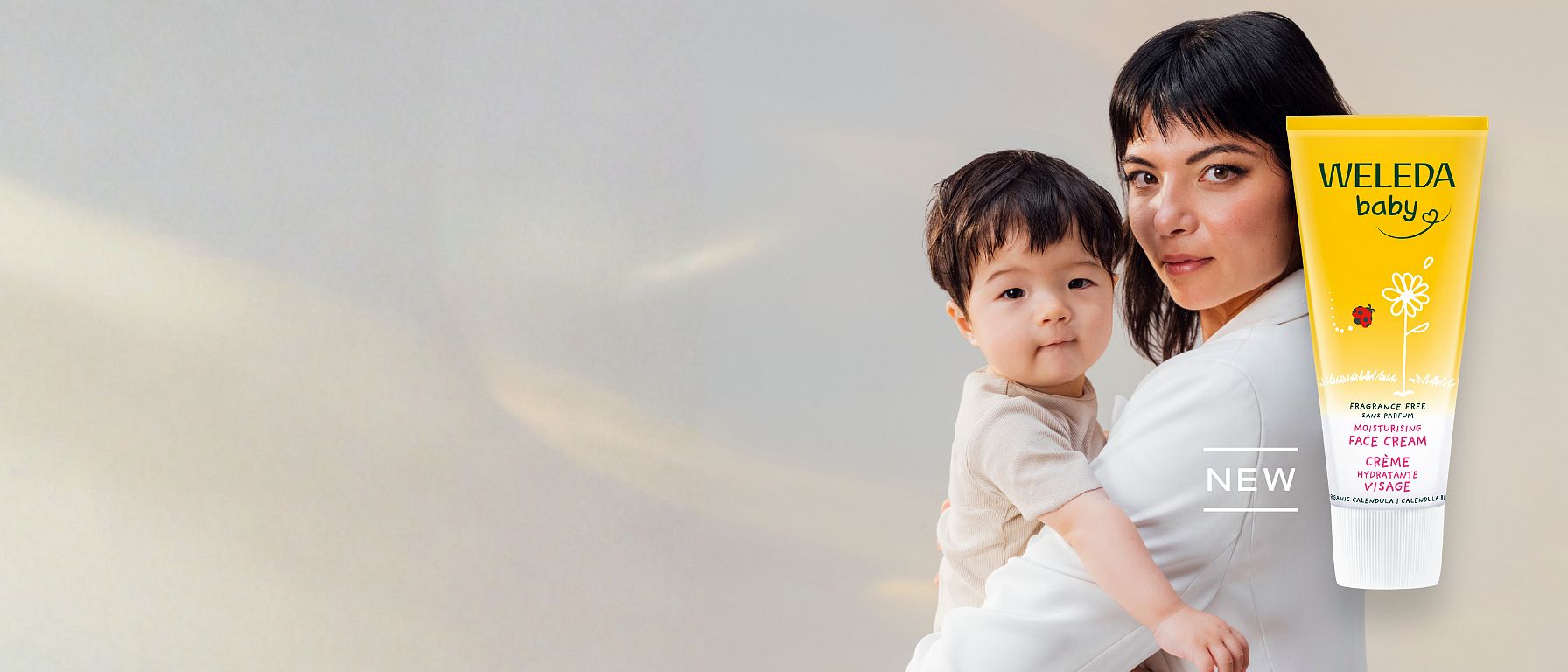 New Weleda Calendula Face Cream Fragrance Free next to asian mother holding her baby.