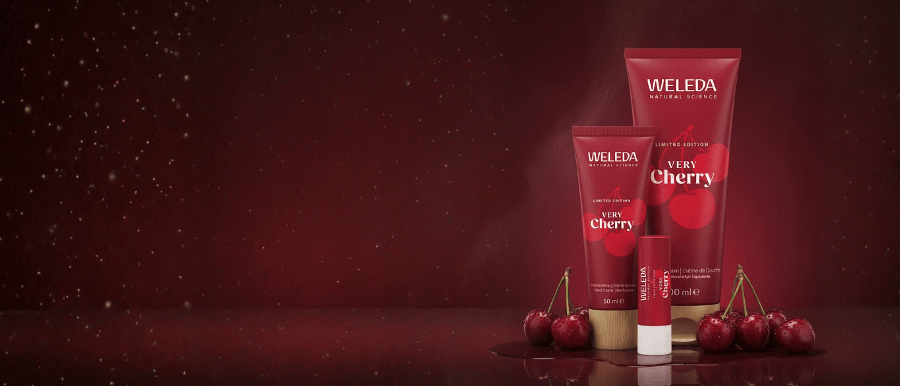 Very Cherry Lip Balm, Shower Cream and hand Cream surrounded by cherries and a red background