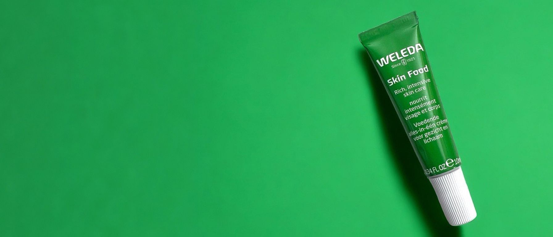 Skin Food 10ml tube on a green background.