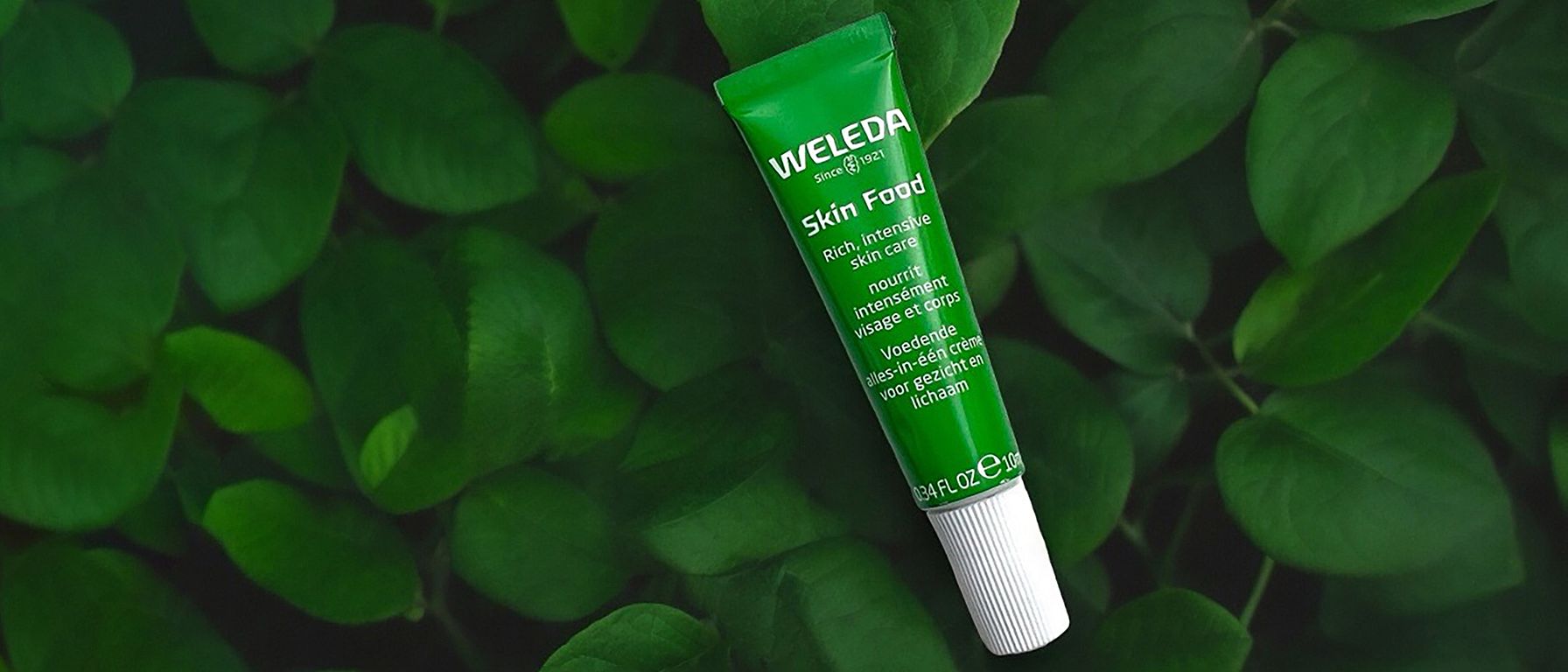 Skin Food 10ml mini on a bed of green leaves.