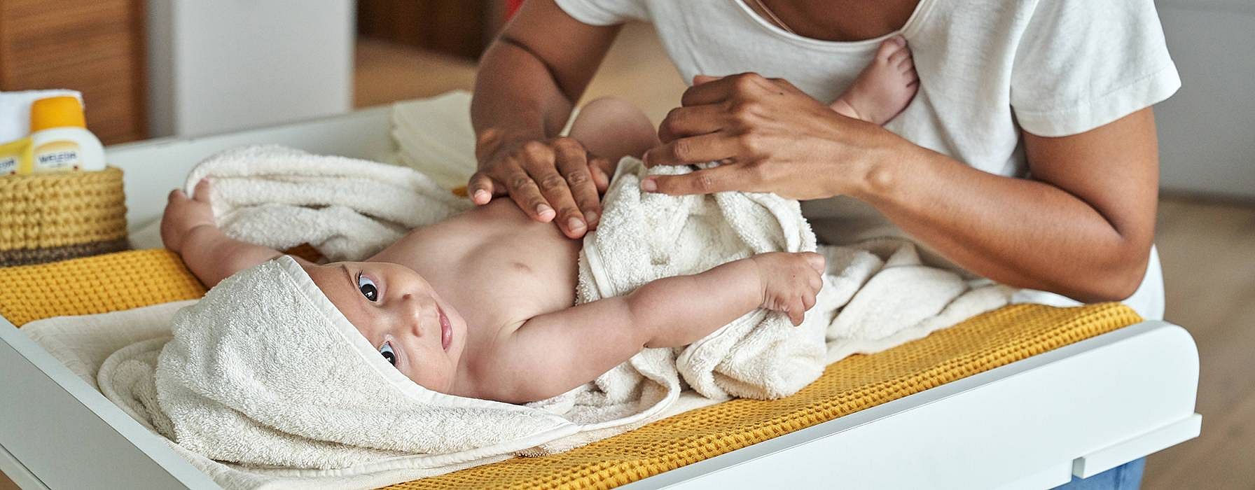 Mother massaging baby