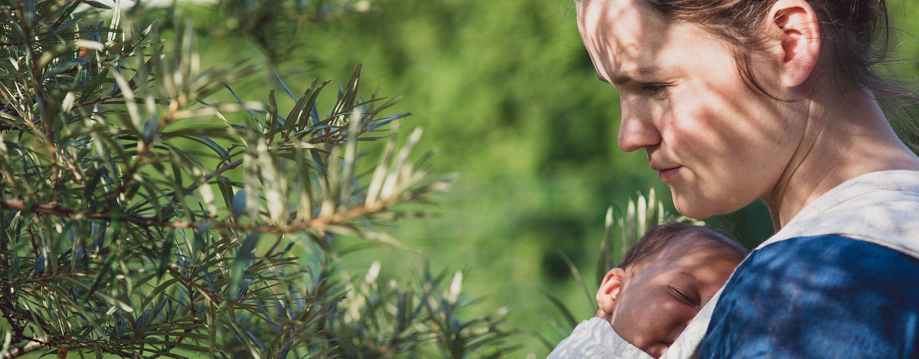 Mother carrying baby in a sling