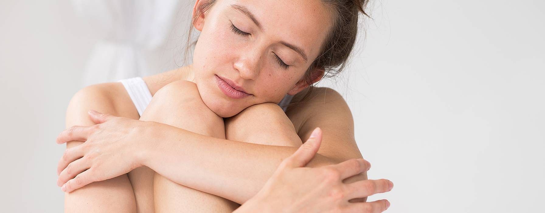 girl hugging legs