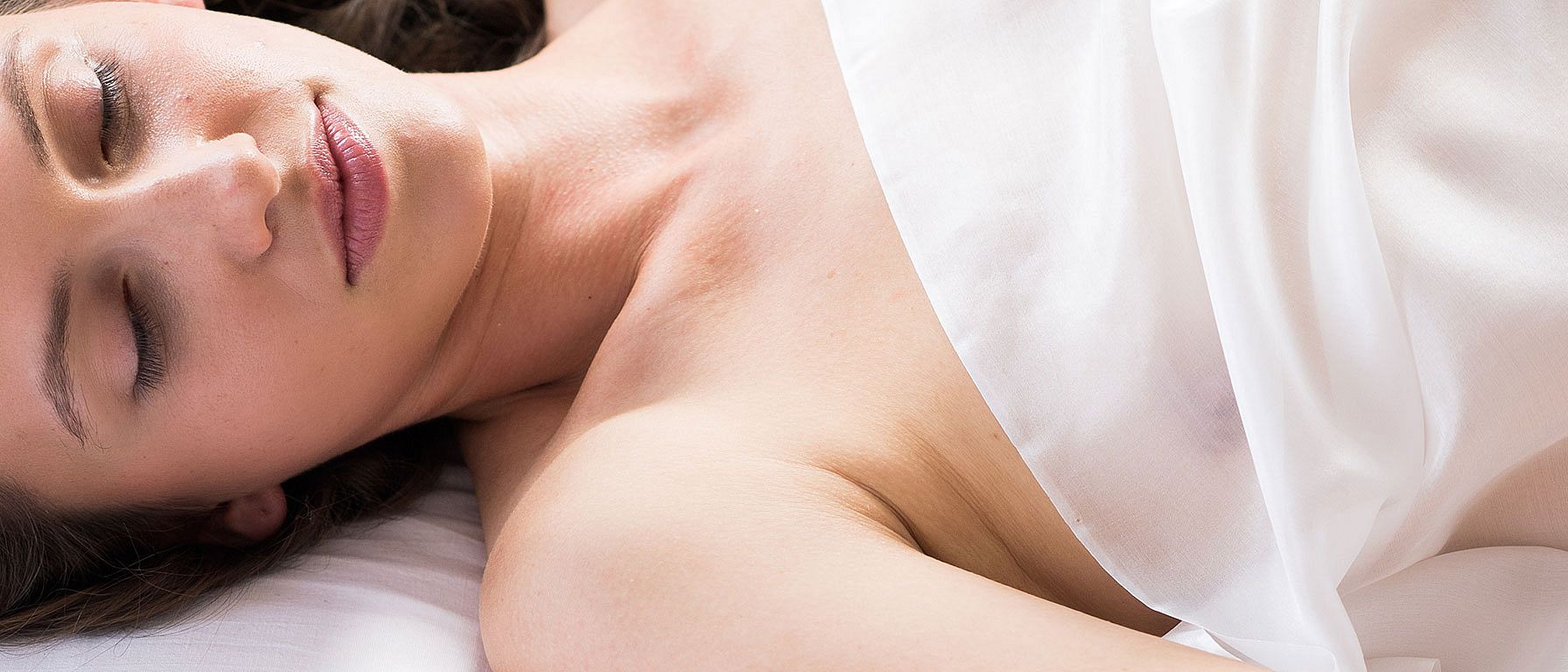young woman lying in bed