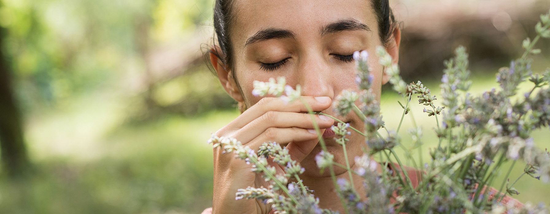 Girl smelling flowers.