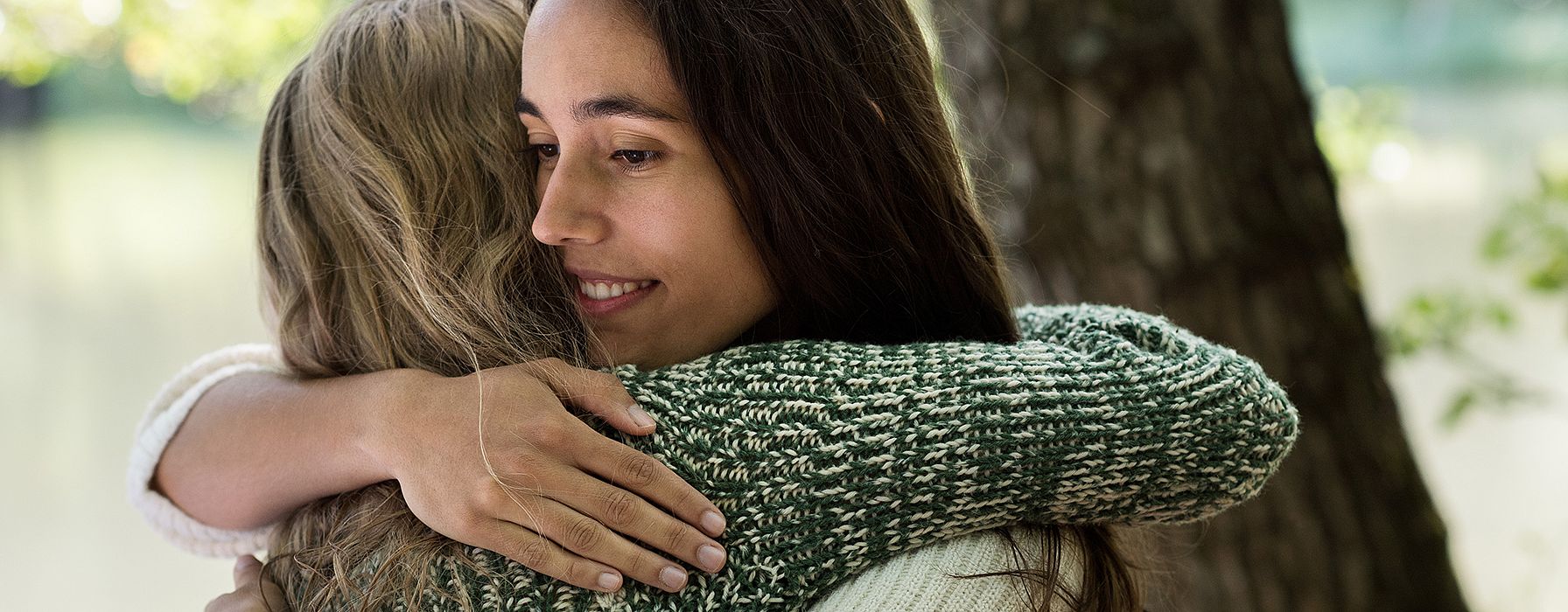Women hugging.