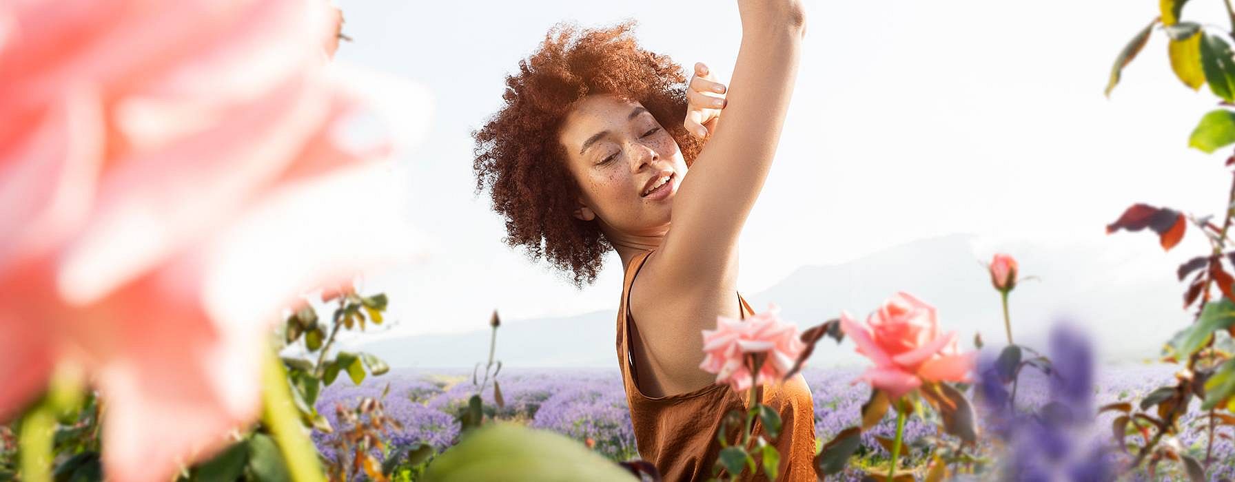Woman smiling in a field of flowers