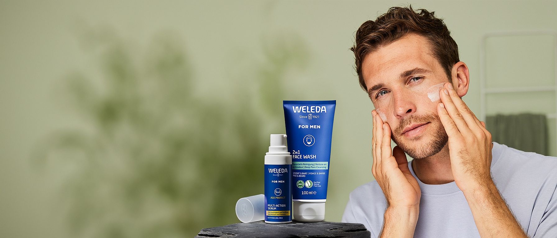 Man in bathroom looking at his face.