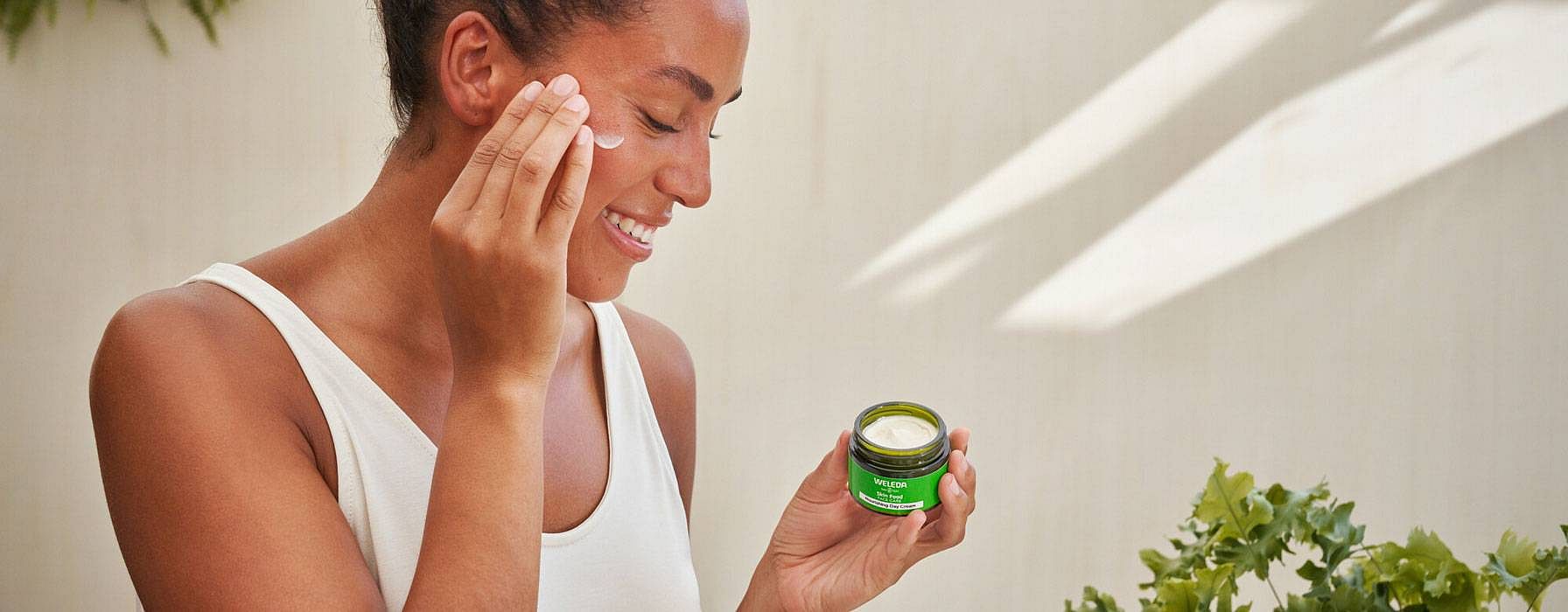 Woman applying skincare to her face