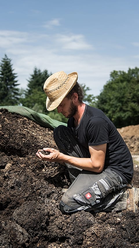 gardeners having compost in his hands