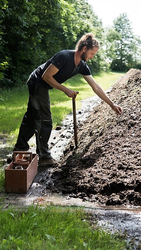 gardener next to compost