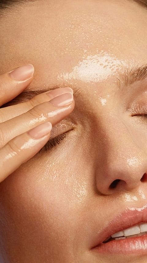 woman applying cleansing oil