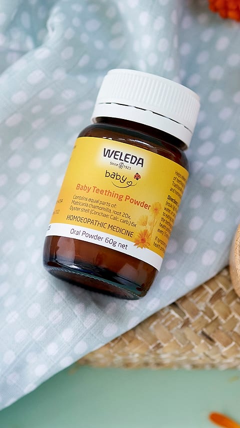 Baby Teething Powder on baby blanket.