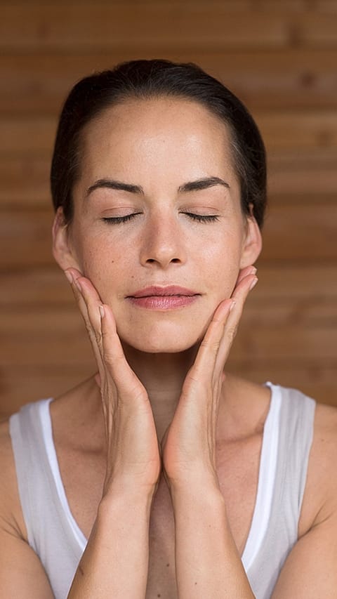 Woman applying face cream