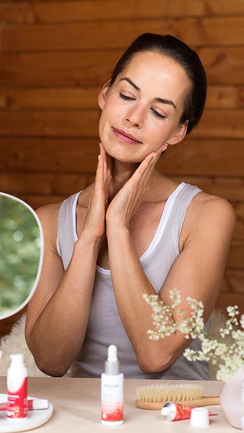 Woman tenderly applying face cream