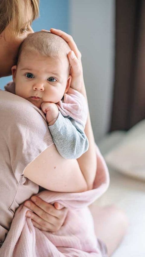 Mother holding baby.