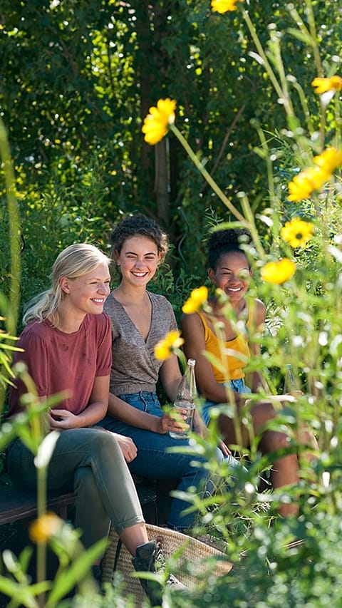 Three tene girls in a garden
