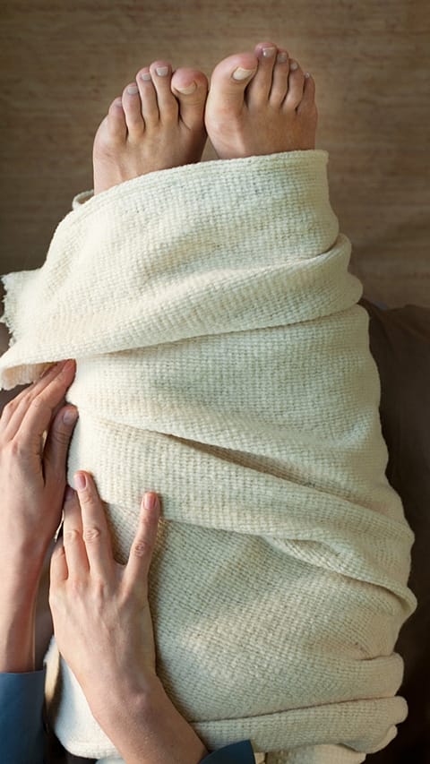 Woman wrapping her legs and feet clseup.