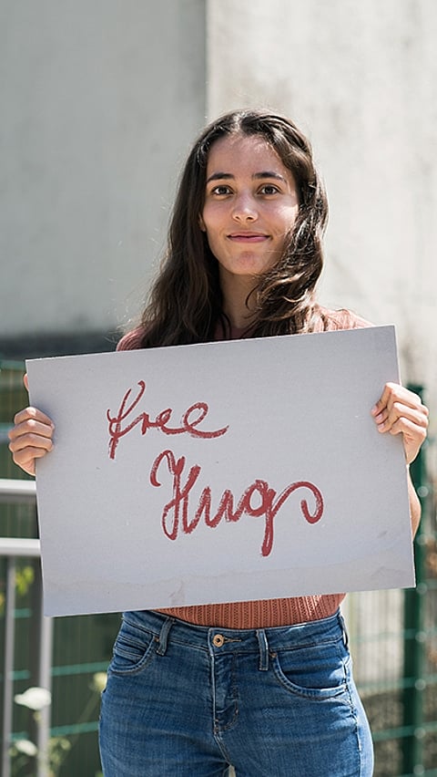 Woman offering free hugs