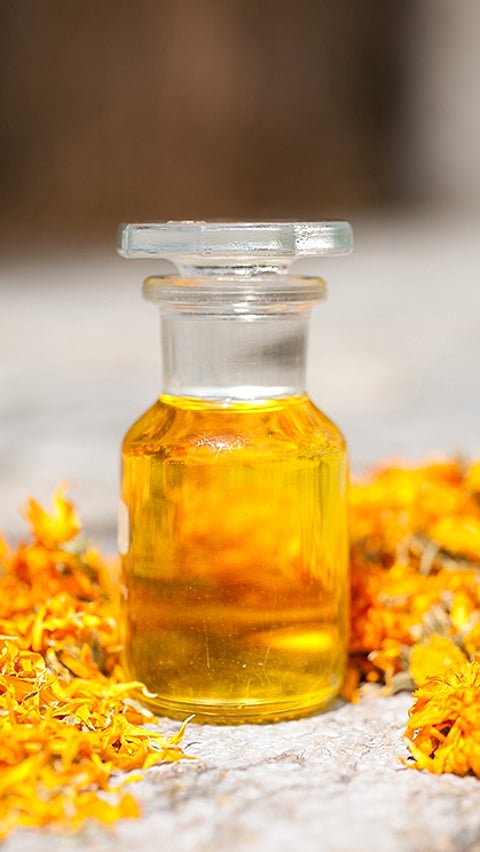 Calendula oil in glass container