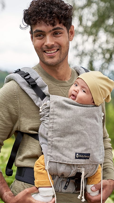 father carrying baby on a baby carrier