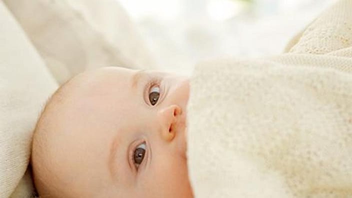 baby wrapped in blanket