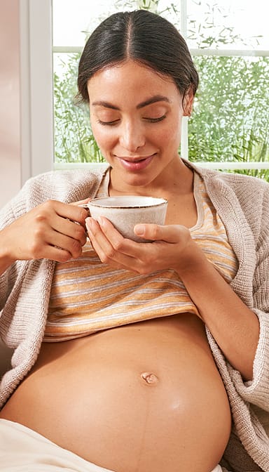 Pregnant woman drinking nursing tea.