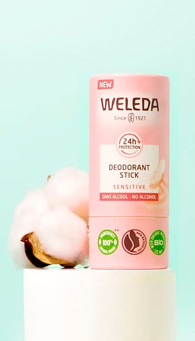 Deodorant Stick Sensitive tube on a plinth next to cotton.