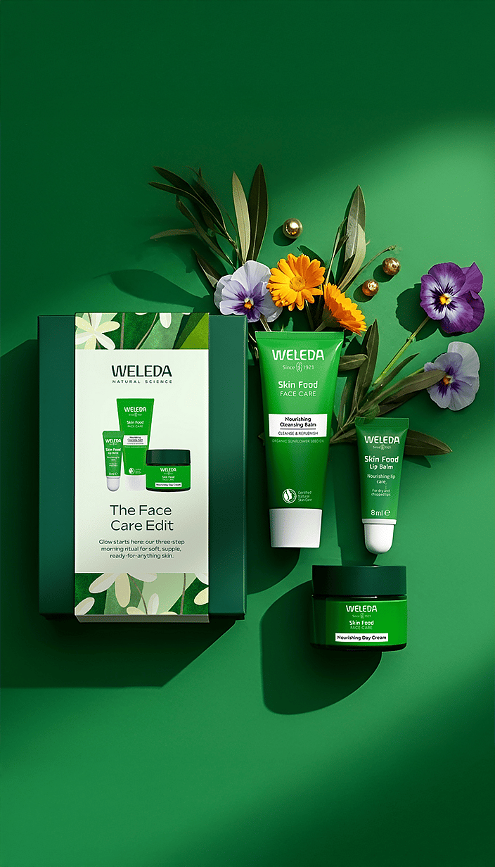 The Face Care Edit Gift Set on green surrounded by background calendula and viola flowers