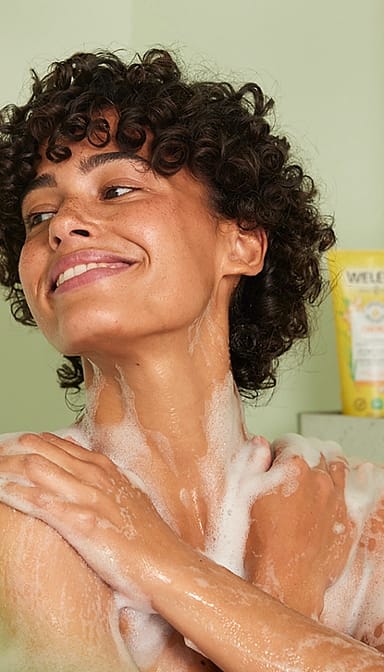 girl showering and smiling