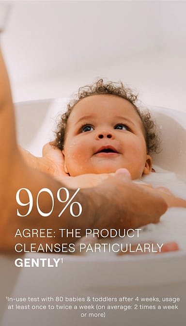 baby bathing and smiling with text.