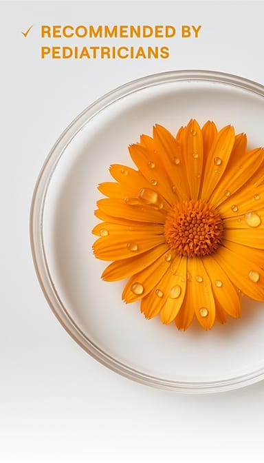 Calendula blossom in liquid in petri jar with text.