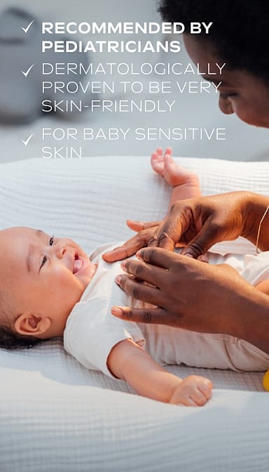 Smiling dark skin baby and mother smiling to him with Calendula nappy change cream fragrance free benefits text.