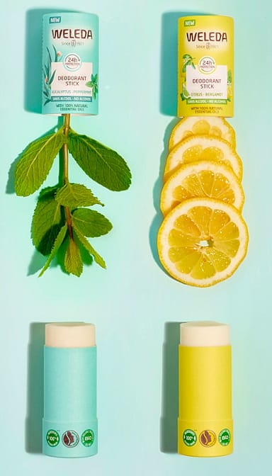 Deodorant Stick Citrus-Bergamot and Eucalyptus-Peppermint opened with peppermint leaves and slices of lemon.