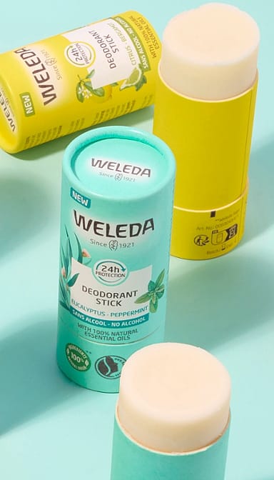 Deodorant Stick Citrus-Bergamot and Eucalyptus-Peppermint open against turquoise background.