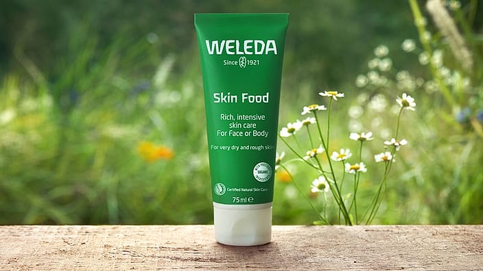 Woman applying cream on elbows