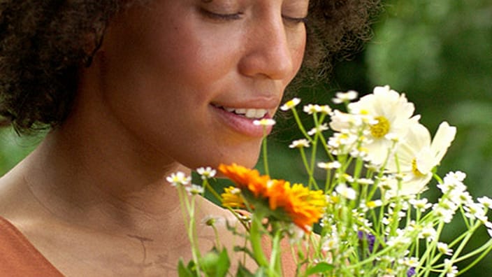 Woman smelling flowers