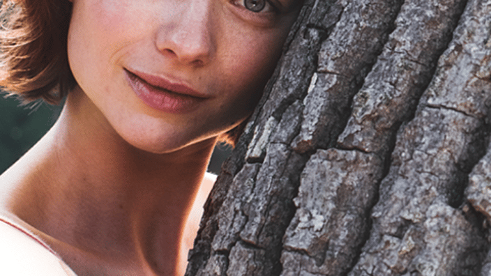 Woman hugging a tree