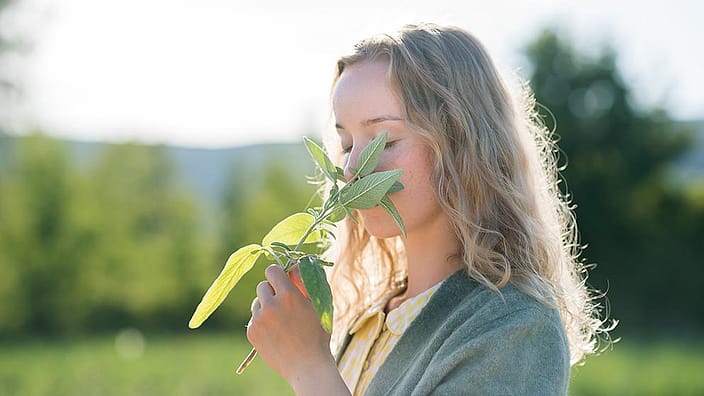girl smelling flowers