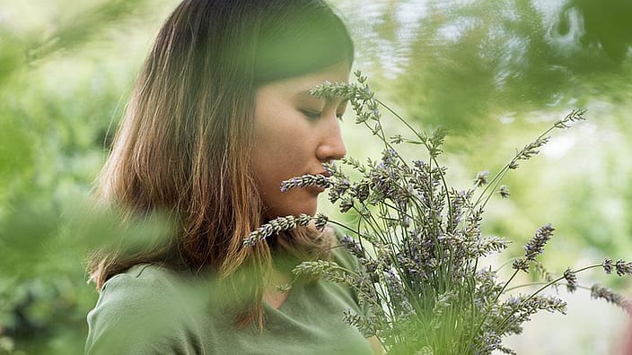 Lady smelling plants