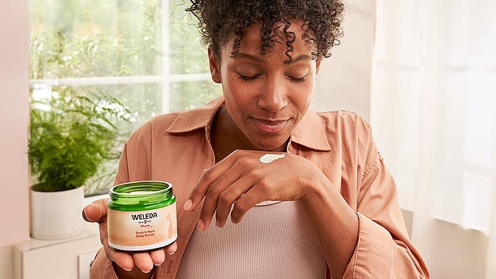 Woman smelling the Stretch Mark Body Butter