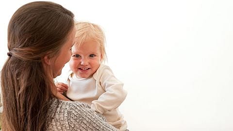 baby on mothers arm