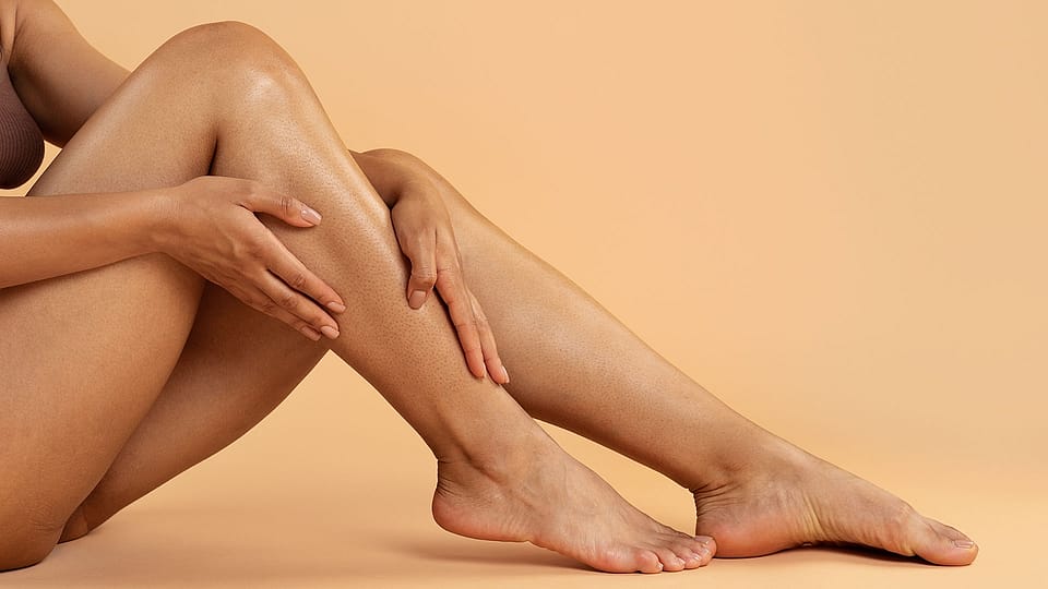 Woman massaging her calves