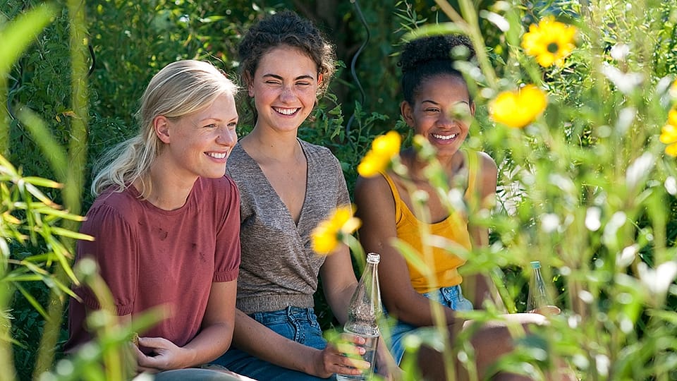 Three teen girls in a garden