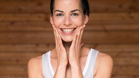 Woman touching her face