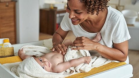 Mother massaging baby